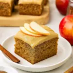 A slice of moist Autumn Apple Cake Recipes with warm brown sugar glaze, showcasing fresh apples, cinnamon spices, and perfect for Fall Time Dessert Recipes lovers.