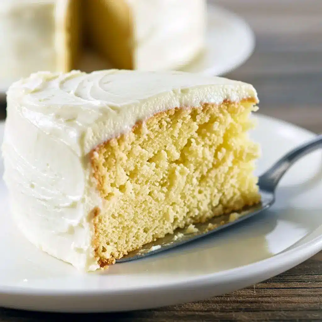 A golden, moist vanilla cake on a cooling rack, sliced to show its soft crumb — perfect for Cake Baking Recipes For Beginners and Simple Tasty Cake Recipes, ideal Birthday Cake Homemade Easy for any celebration.
