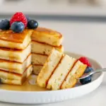 Stack of golden Extra Fluffy Protein Pancakes topped with syrup and berries — an easy, high-protein breakfast made from Pe Science Protein Recipes, perfect Bulking Pancakes for meal prep or quick weekday mornings.