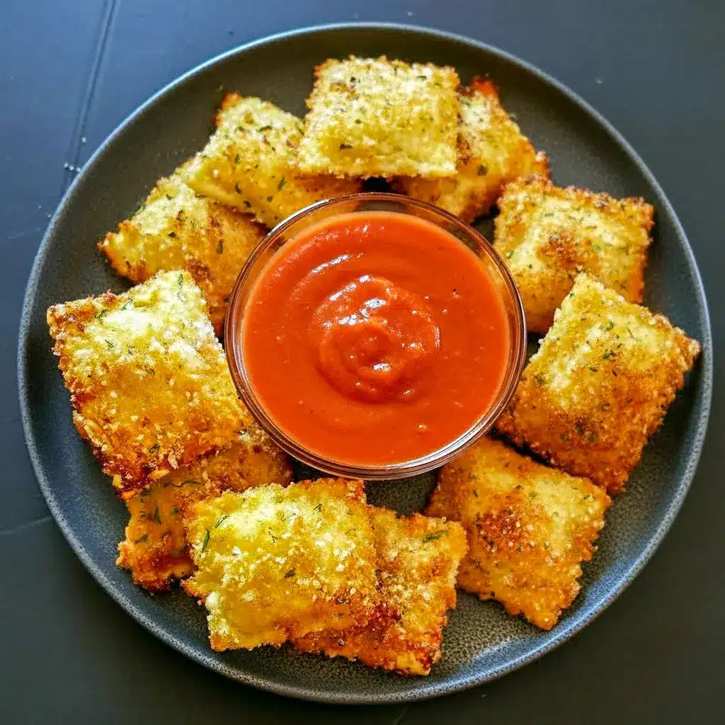 Plate of Air Fryer Ravioli served with marinara sauce—golden brown, crunchy Crispy Toasted Ravioli perfect for Noodle Appetizers or cozy Appy Dinner Ideas.