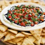 A platter of Tomato Basil Dip, a Cheesy Bruschetta Dish made with creamy herbed cheese, chopped tomatoes, fresh basil, and a drizzle of balsamic glaze—perfect for Bread And Dip Appetizers or Bruschetta Appetizer Party Ideas.