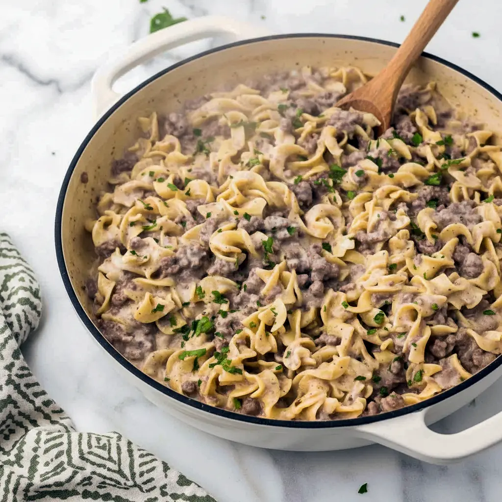 Creamy Ground Beef Stroganoff piled on egg noodles with parsley, a quick Fast Dinner Recipe that’s family-friendly.