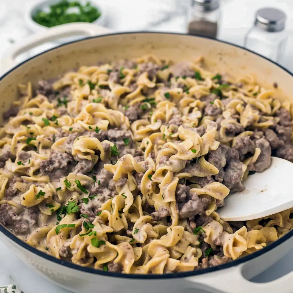 Creamy Ground Beef Stroganoff piled on egg noodles with parsley, a quick Fast Dinner Recipe that’s family-friendly.
