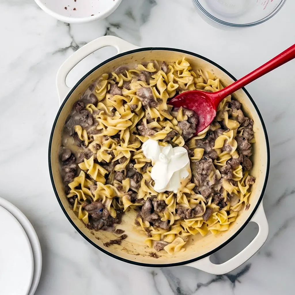 Creamy Ground Beef Stroganoff piled on egg noodles with parsley, a quick Fast Dinner Recipe that’s family-friendly.