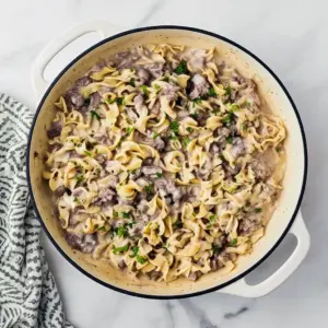 Creamy Ground Beef Stroganoff piled on egg noodles with parsley, a quick Fast Dinner Recipe that’s family-friendly.