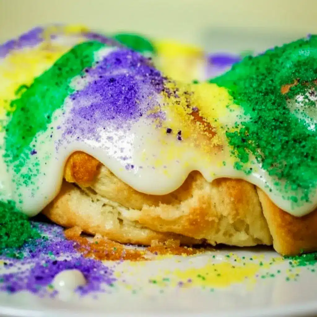 Golden braided King Cake Recipe drizzled with glaze and sprinkled in purple, green, and gold — a no-fuss Simple King Cake Recipe for Mardi Gras.