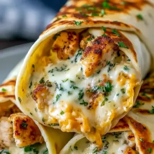 Diagonal-cut Cheesy Garlic Chicken Wrap with golden crust and gooey cheese pull — a hearty High Protein Dinner and perfect Low Carb Chicken Wrap for meal prep.