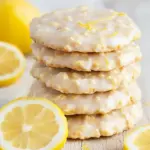 Lemon No-Bake Oatmeal Cookies stacked on parchment with fresh lemon zest and oats visible — a bright Quick Oatmeal Recipe perfect for on-the-go snacking.