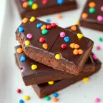 Cosmic Brownies topped with glossy ganache and colorful candy chips, styled as a rich Dessert To Bring or Quick Party Dessert.