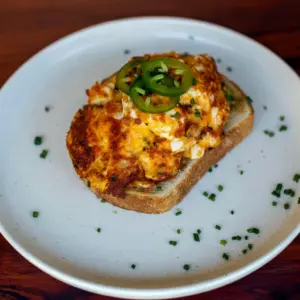 A slice of toast topped with Crispy Egg Salad, avocado, and jalapeño for a quick and satisfying lunch made with Healthy Recipes With Boiled Eggs.