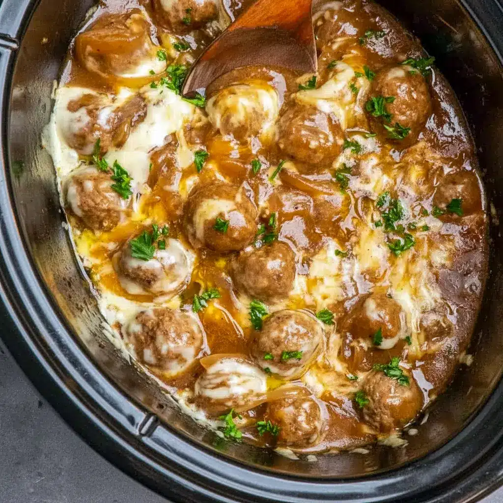 Crock Pot French Onion Meatballs topped with melted cheese in a slow cooker — perfect Crockpot Party Food Crowd Pleasers.