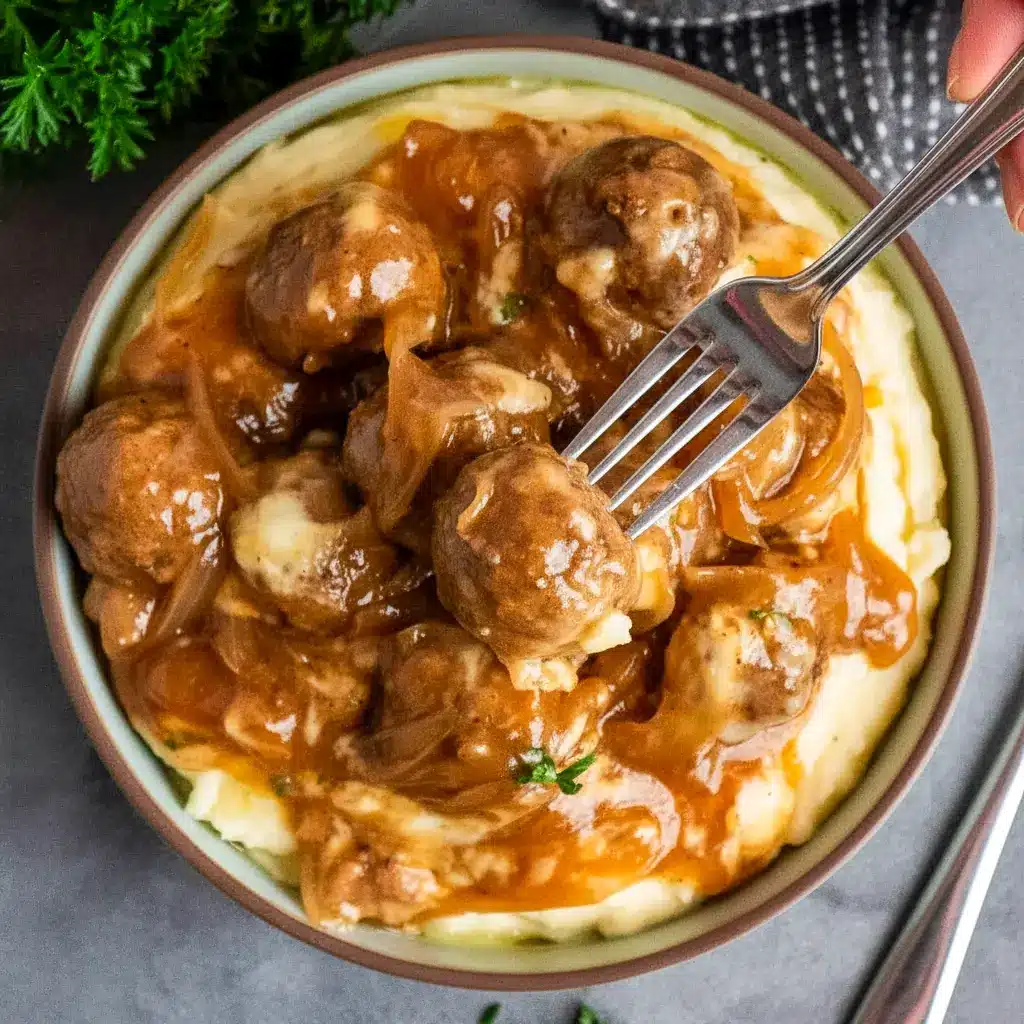 Crock Pot French Onion Meatballs topped with melted cheese in a slow cooker — perfect Crockpot Party Food Crowd Pleasers.
