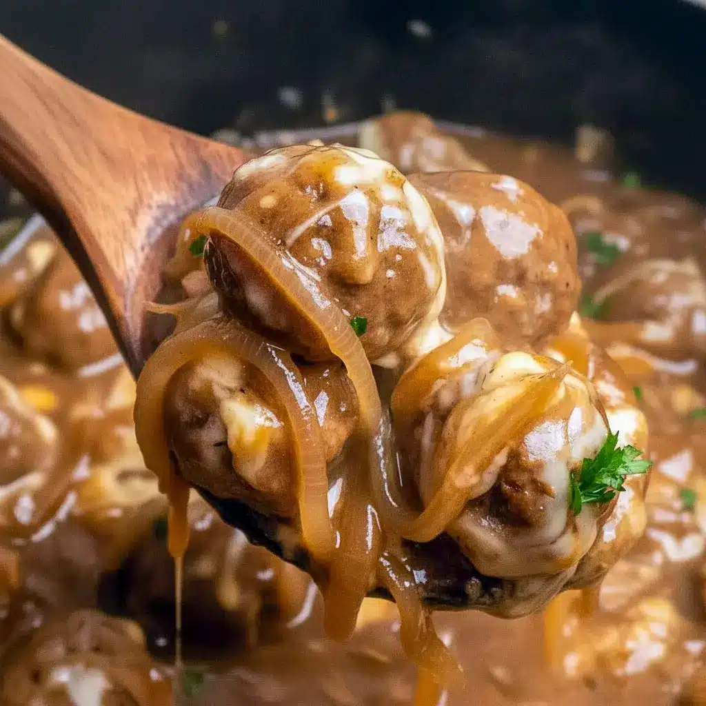 Crock Pot French Onion Meatballs topped with melted cheese in a slow cooker — perfect Crockpot Party Food Crowd Pleasers.