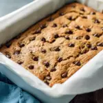 Banana Bread Blondies — golden, gooey bars studded with chocolate chips; perfect for using up ripe fruit.