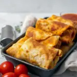 Tray of golden Pepperoni Pizza Rolls with a crispy outside and cheesy beef filling, served as a quick high-protein snack.