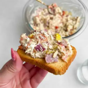 Italian Grinder Chicken Salad on a toasted croissant with provolone, banana peppers, cherry tomatoes, and a sprinkle of parmesan.