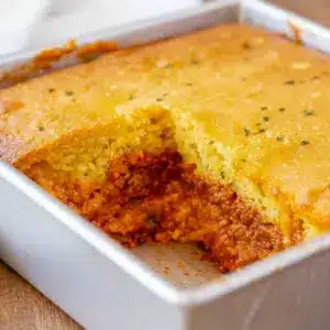 A hearty serving of BBQ Chicken Cornbread Casserole with golden cornbread topping, melted cheese, and barbecue chicken filling, styled as a comforting Barbecue Chicken Cornbread Casserole for Meals To Go With Cornbread.