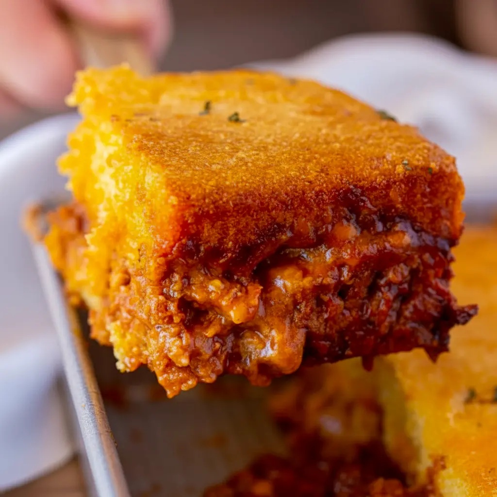 A hearty serving of BBQ Chicken Cornbread Casserole with golden cornbread topping, melted cheese, and barbecue chicken filling, styled as a comforting Barbecue Chicken Cornbread Casserole for Meals To Go With Cornbread.