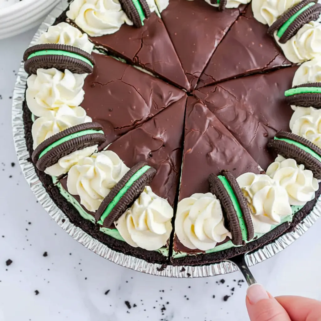 A chilled slice of Grasshopper Pie with smooth mint layers and chocolate topping, styled as a classic Grasshopper Cheesecake for dessert lovers.