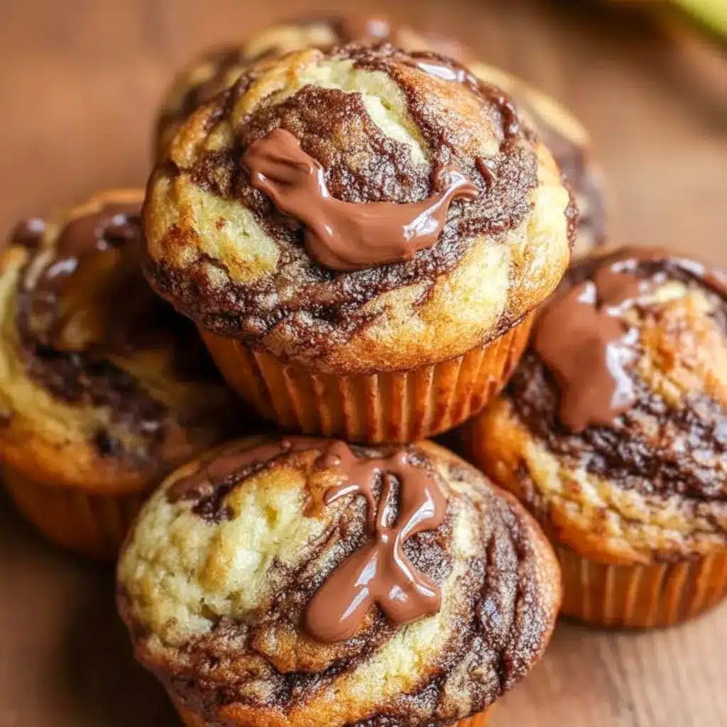 A tray of Nutella Banana Swirl Muffins with glossy bakery-style tops, styled as a sweet example of How To Make Nutella Swirl Muffins.