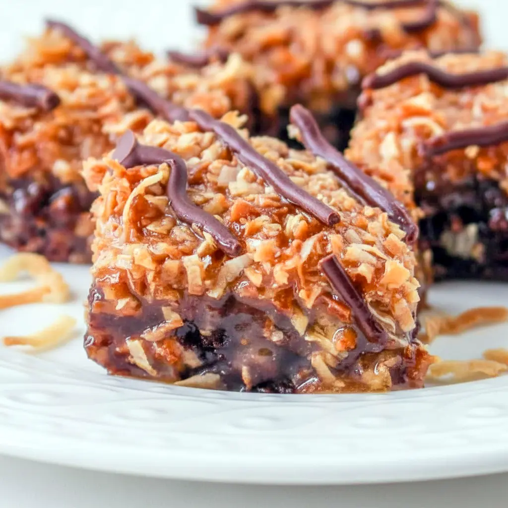 Tray of Samoa Brownies topped with toasted coconut, caramel, and chocolate drizzle, styled as a rich Coconut Brownie dessert for Dessert Recipes With Caramel lovers.