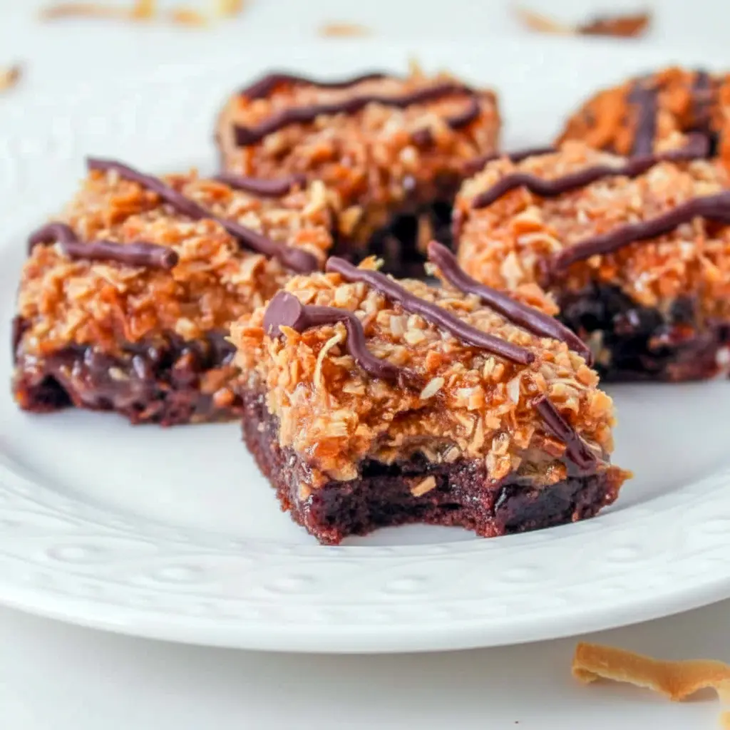 Tray of Samoa Brownies topped with toasted coconut, caramel, and chocolate drizzle, styled as a rich Coconut Brownie dessert for Dessert Recipes With Caramel lovers.