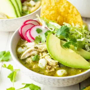 Pozole Verde de Pollo simmering in a rustic bowl, styled as a cozy Green Chili Chicken Pozole dinner with fresh lime and cilantro.