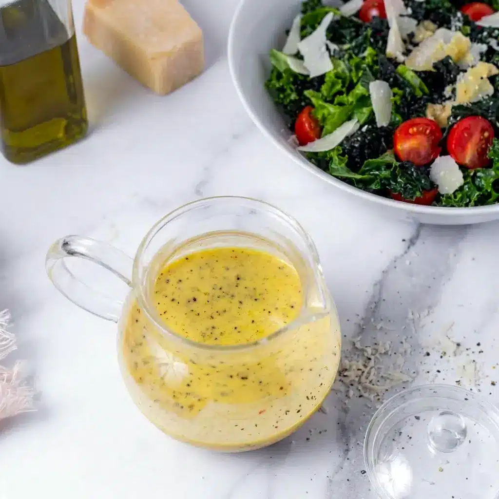 Parmesan Vinaigrette Dressing served in a small bowl with crisp greens for a fresh Delicious Vinaigrette look.