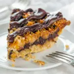 A gooey slice of Samoas Pie with chocolate drizzle, caramel, and coconut for Super Sweet Desserts lovers.