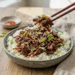 Slow Cooker Korean Beef served over fluffy rice with a glossy sauce, making it the perfect Over Rice Meals idea for an easy dinner.