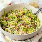 Famous La Scala Chopped Salad served as a crisp Chopped Salad With Dressing with lettuce, salami, chickpeas, and mozzarella.