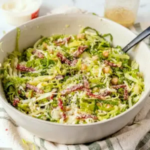 Famous La Scala Chopped Salad served as a crisp Chopped Salad With Dressing with lettuce, salami, chickpeas, and mozzarella.