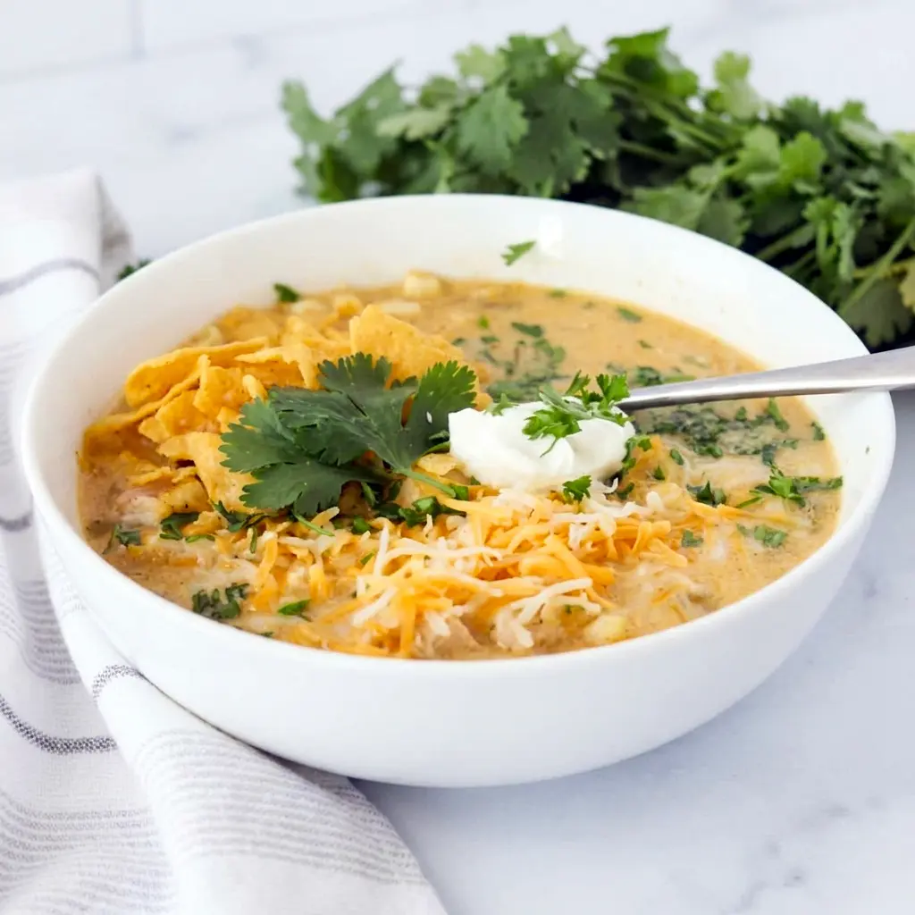 Green Chile Chicken Enchilada Soup is a comforting Creamy Green Chili Chicken Stew with bold flavor and a rich, hearty texture.