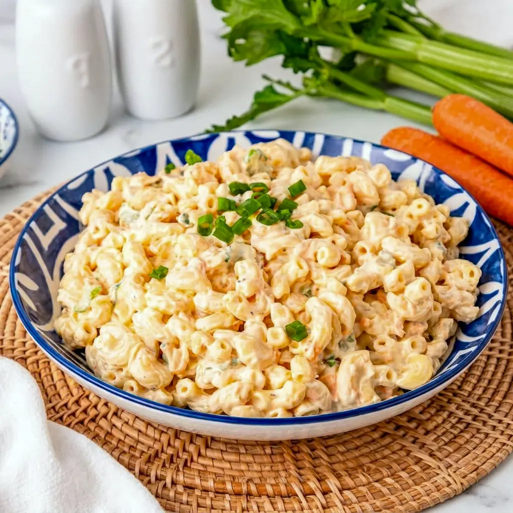 Hawaiian Macaroni Salad displayed as one of the Best Party Dishes, served cold beside grilled favorites for a potluck spread.