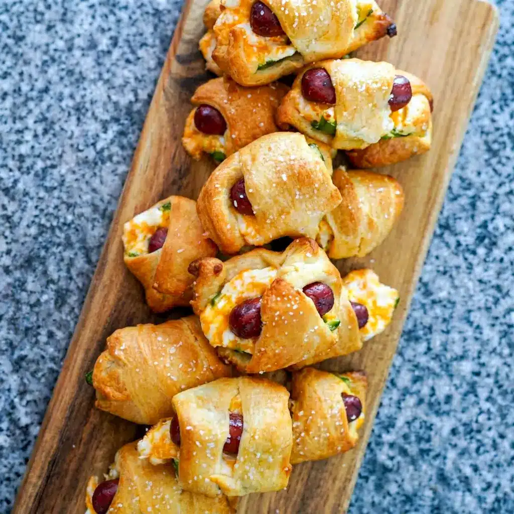 A party tray of Jalapeño Popper Pigs in a Blanket with dipping sauce, perfect as Super Bowl Easy Appetizers for guests.