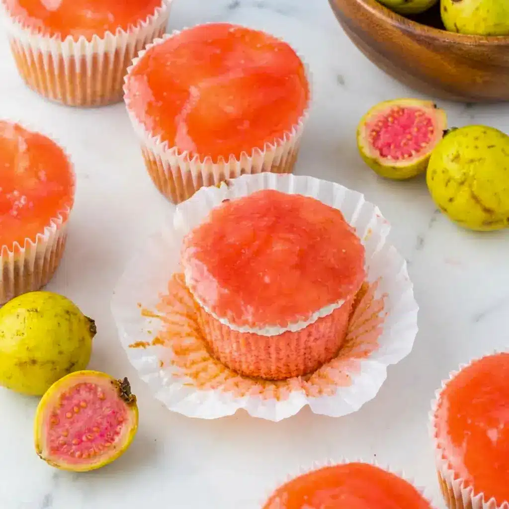 Mini Hawaiian Guava Cake cupcakes with soft strawberry sponge and shiny guava glaze, shown with fluffy Guava Frosting for a tropical party treat.