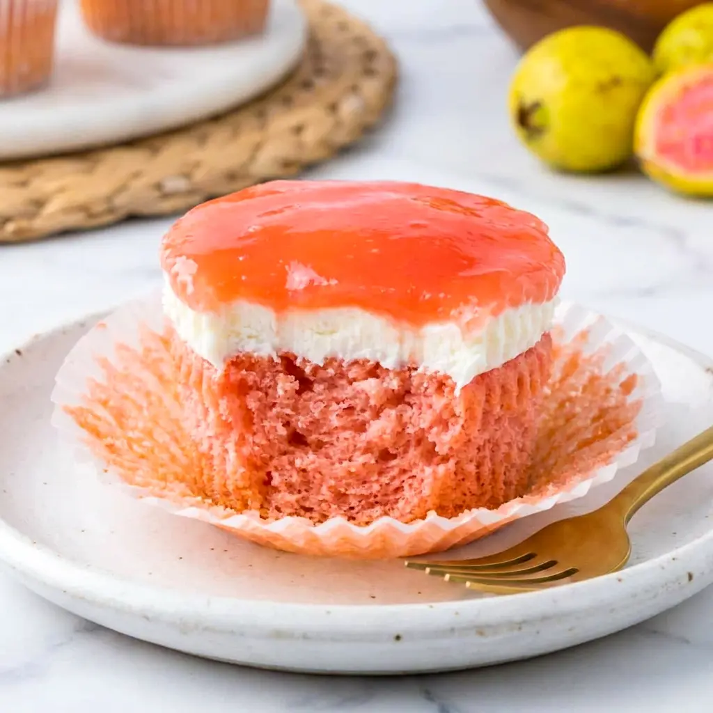 A tray of Mini Hawaiian Guava Cake desserts topped with bright glaze and coconut, presented as playful Mini Hawaiian Guava Cakes for special gatherings.