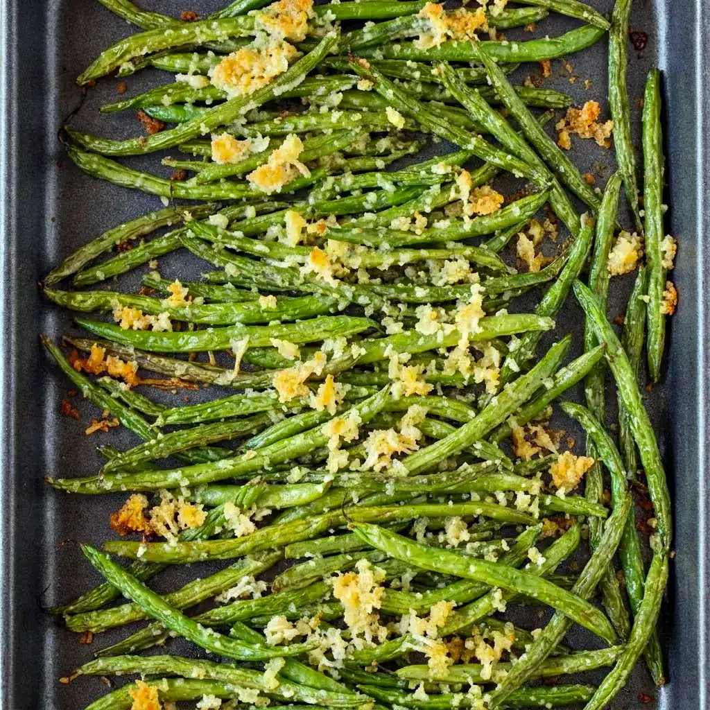 A close-up of Roasted Parmesan Green Beans with a crispy golden topping, perfect for Healthy Carbs Side Dishes at an easy family dinner.