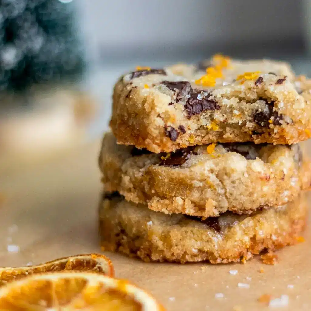 Dark Chocolate Orange Shortbread Cookies baked into Winter Shortbread Cookies, sliced neatly on a tray and finished with orange zest for a holiday look.