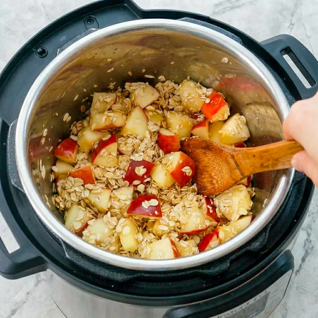 Rustic bowl of Instant Pot Apple Cinnamon Oatmeal made with soft apples, a hearty Instant Pot Apple Pie Steel Cut Oats Oatmeal style breakfast.