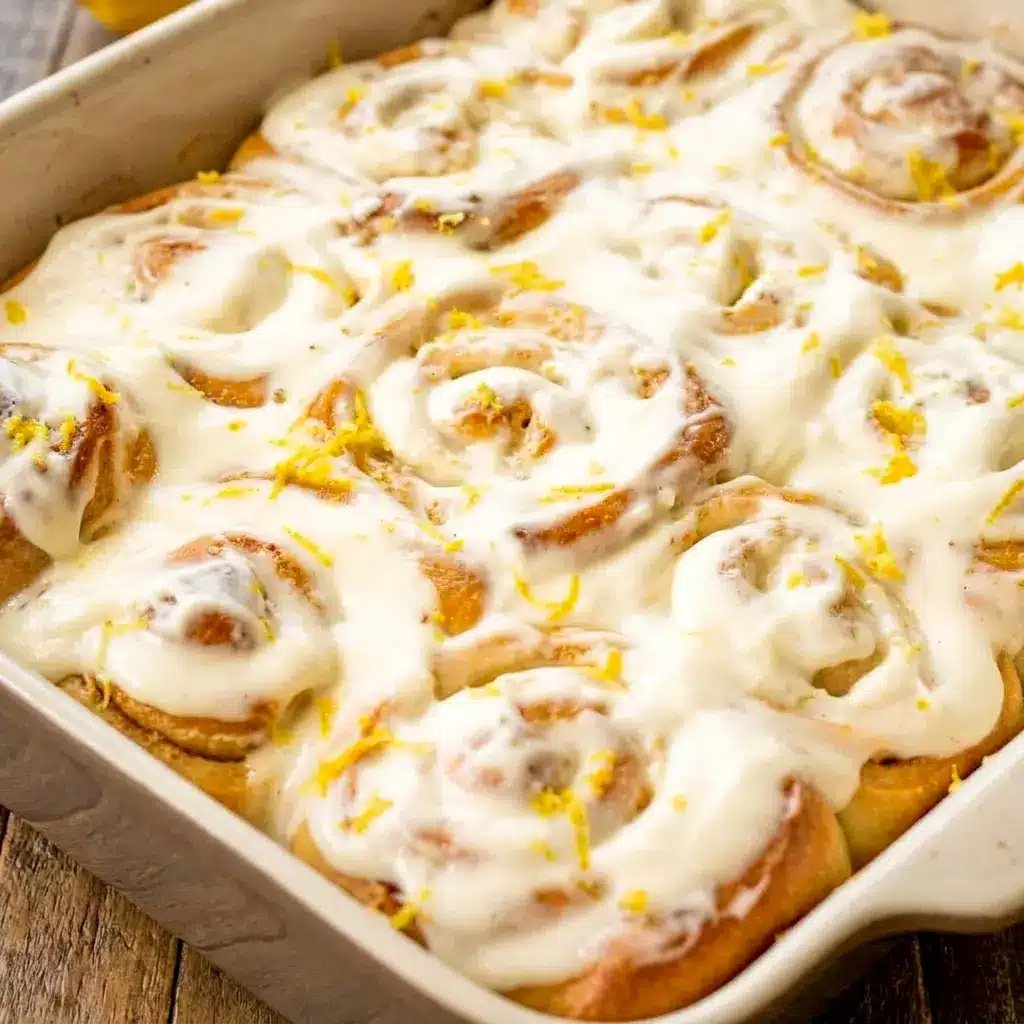 Lemon Sweet Rolls pulled apart to show fluffy layers, an easy spring bake inspired by Lemon Cinnamon Rolls.