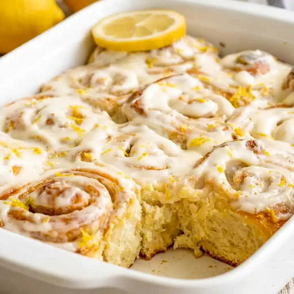 Lemon Sweet Rolls served with extra zest on top, a beautiful choice for Homemade Lemon Dessert Rolls and sweet mornings.