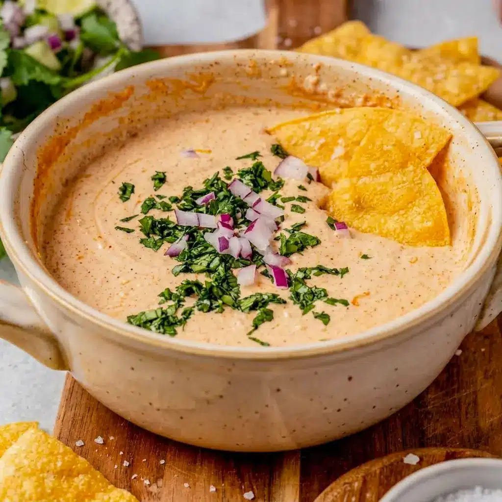 Cottage Cheese Queso Dip styled like a quick Cottage Cheese Spread Recipe, shown in a small bowl with colorful veggie dippers.