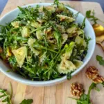 Fresh and vibrant, Lemon Arugula Pasta Salad is served in a bright bowl with a light Arugula Pasta style finish and fresh lemon zest.