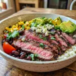 Cilantro Lime Steak Bowls on a colorful plate with Southwestern Steak Bowl flavors, grilled steak, rice, avocado, and fresh toppings.