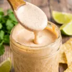 Taco Salad Dressing drizzled over a colorful taco bowl with fresh lettuce, tomatoes, cheese, and a creamy Homemade Taco Salad Dressing finish.