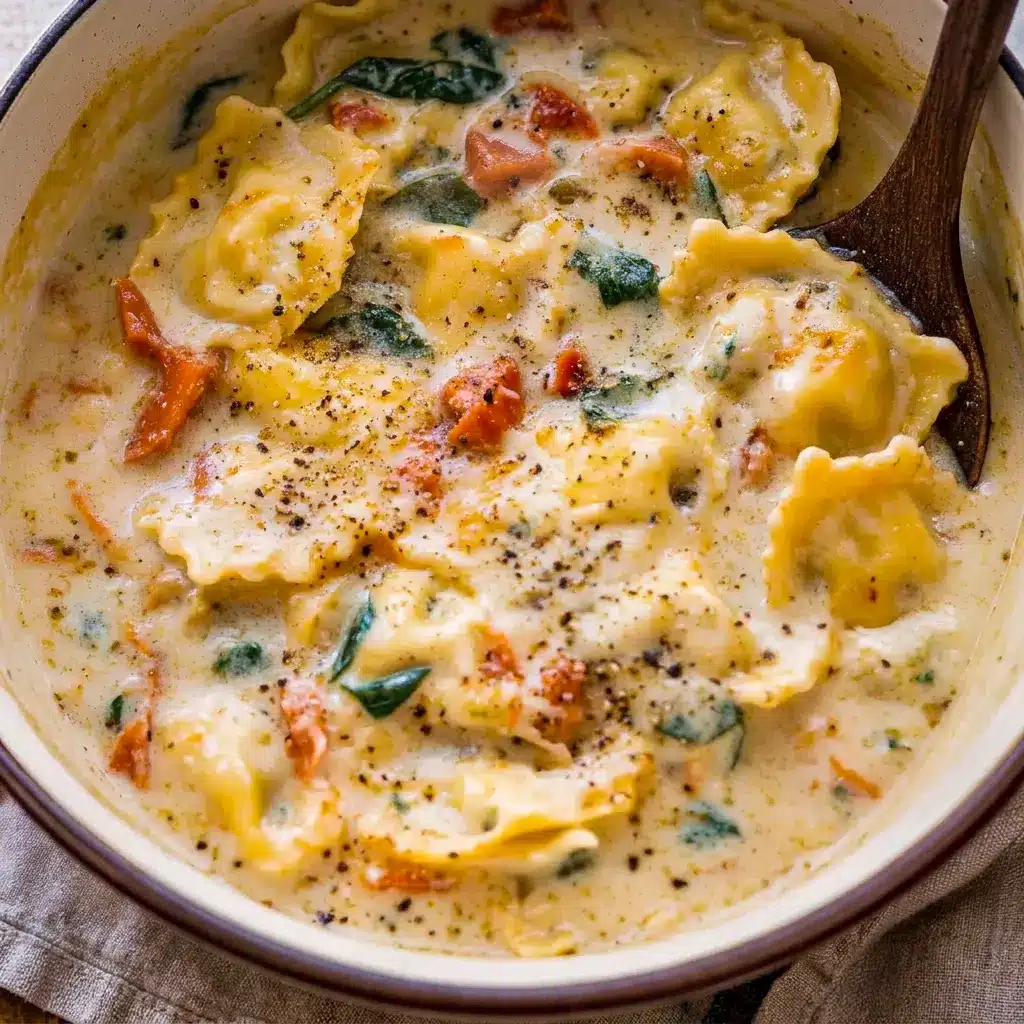 A rich bowl of Creamy Tuscan Ravioli Soup with garlic bread on the side, ideal for Best Fall Food Recipes and cozy comfort food dinners.
