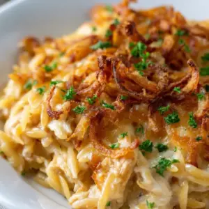 A cozy French Onion Chicken Orzo Casserole baked in one pan, styled as a Chicken Dinner with golden cheese and rich, comforting layers.