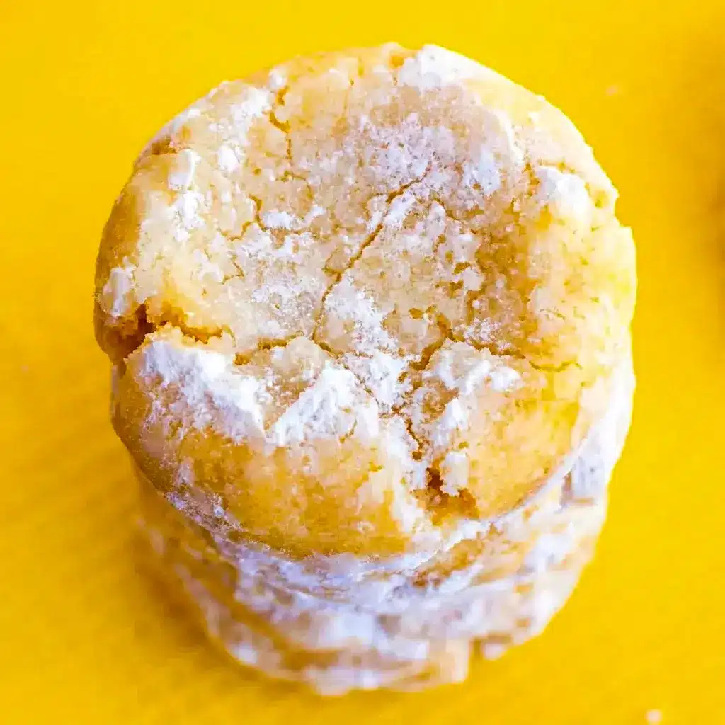 A batch of Lemon Pixie Cookies cooling on parchment paper for Non Flour Desserts with a soft, tender bite and bold lemon flavor.