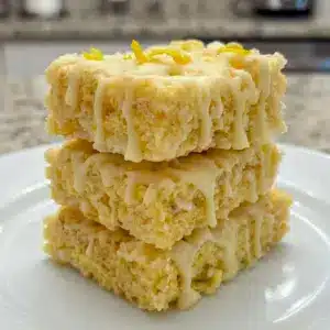 Bright Lemon Rice Krispy Treats stacked on a tray, styled as one of the best Different Rice Crispy Treats for spring dessert boards.